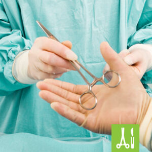 Gloved hand holding surgical instruments